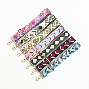 Detailed view of adjustable ethnic style woven bag straps with gold metal hooks and buckles