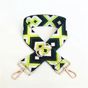 Detail of adjustable geometric diamond pattern bag strap with gold lobster clasps