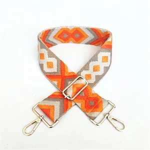 Ethnic style adjustable shoulder strap with orange geometric pattern and gold hardware