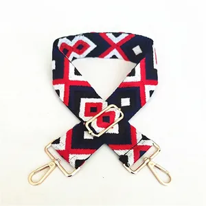 Adjustable wide woven guitar-style bag strap with red and blue ethnic geometric patterns