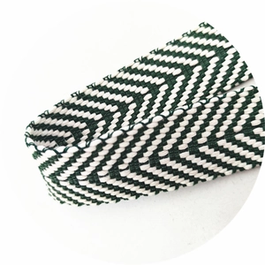 Detail of green and white chevron woven strap with thick herringbone texture for bags