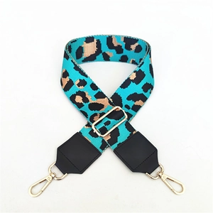 Detail of adjustable leopard print bag strap with blue base and golden metal lobster clips