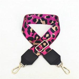 Detailed leopard print bag strap with pink accents and golden metal hardware buckles