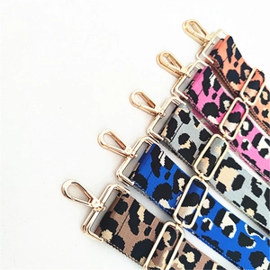 Detailed view of wide leopard print bag straps with gold metal clasps in five colors