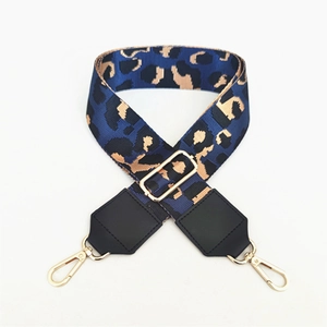 Detail view of leopard print wide strap with gold-tone hardware and adjustable buckle