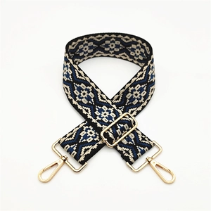 Detail of adjustable ethnic geometric pattern strap with golden metal lobster clasps