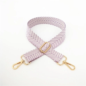 Close-up of lilac woven herringbone purse strap with polished gold metal buckles