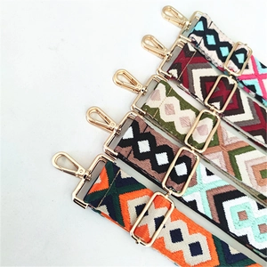 Detail of bohemian ethnic patterned bag straps with gold metal hooks and buckles