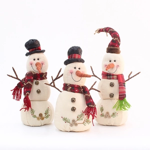 Three festive burlap snowman figurines with plaid hats and scarves for Christmas decor