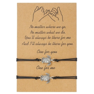 Set of two woven turtle bracelets on a craft paper gift card with a warm message
