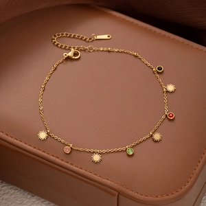 Golden stainless steel anklet featuring multi-colored zircons and sun pendants on leather