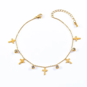 Gold titanium anklet with cross charms and clear crystals on a white background