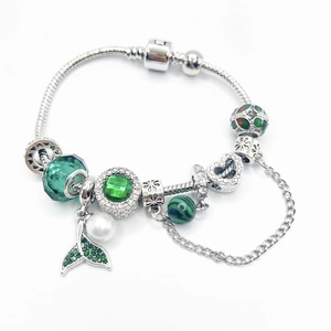 Elegant silver snake chain bracelet with green fish tail charms and white pearls