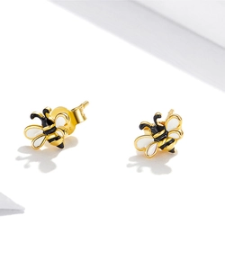 Detailed macro view of S925 silver bee studs with gold plating and enamel stripes
