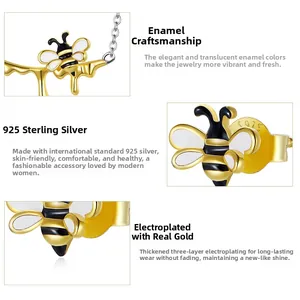 Detailed view of S925 sterling silver honey bee earrings with gold plating and white enamel
