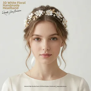 Close-up of handmade bridal headband with white fabric flowers and golden leaves