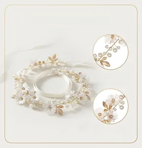 Detail of handcrafted floral bridal headband with 3D fabric flowers and pearls