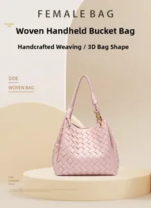 Macro detail of the light pink hand-woven leather texture and metal knot buckle on the bag