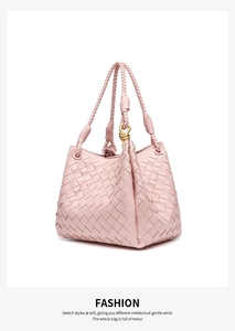 Detailed view of pink woven leather texture with gold metal knot hardware on the strap