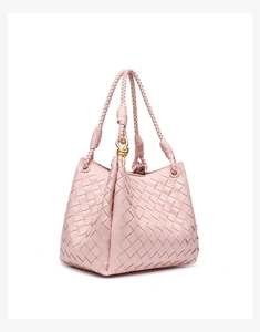 Close-up of pink woven leather texture with a signature gold knot metal buckle detail