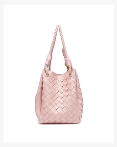 Detail of the light pink woven leather texture and handles on the handmade tote bag