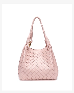 Detailed view of pink woven leather texture with a gold metal knot buckle on a hobo bag