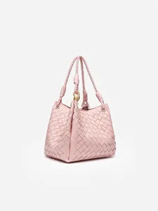 Handwoven leather tote bag in dusty pink with golden metal clasp and woven handles