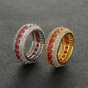 Detailed close-up of micro-paved gold and silver rings with sparkling red ruby-colored stones