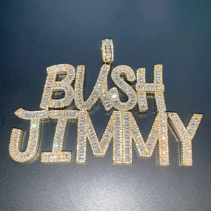 Close-up of gold iced-out BUSH JIMMY razor blade pendant with micro-pave zircons