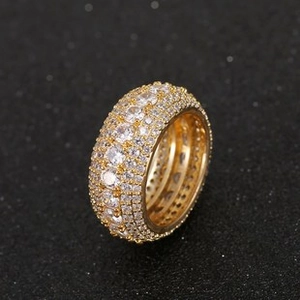 Macro shot of gold wide-band hip hop ring with multi-row pave setting cubic zirconia