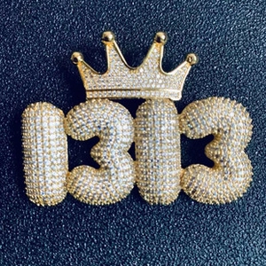 Detailed view of hip hop 1313 crown pendant with micro-paved sparkling zircons