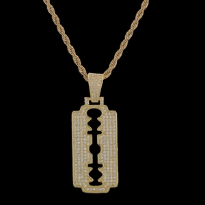 Macro shot of hip-hop razor blade pendant with micro-paved zircons on gold rope chain