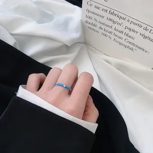 Detailed view of an adjustable S925 silver ring with sky blue enamel and sparkling white zircons