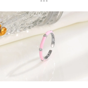 Macro shot of S925 silver ring featuring pink enamel and three sparkling zircons