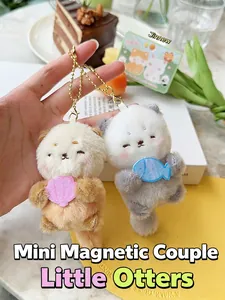 Macro detail of magnetic plush otter keychains with soft fur and hand-held sea shells
