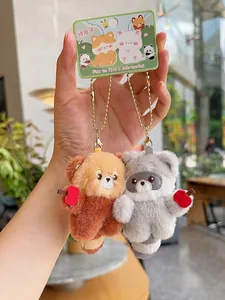 Close-up of plush panda and raccoon keychains with red hearts and magnetic attraction