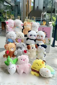 Collection of magnetic plush animal keychains including pandas and sheep displayed outdoors