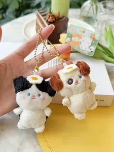Close-up of magnetic plush dog keychains in black and white with fried egg details