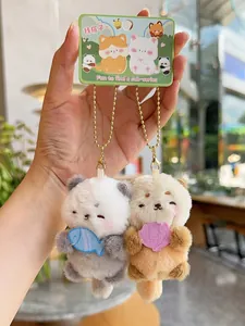 Detail of cute magnetic plush bear keychains with metal chains in hand display