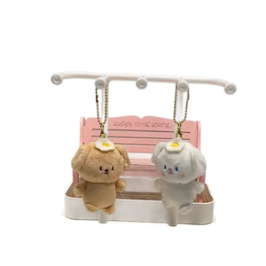 Magnetic dog plush keychains in brown and white with egg hats and gold bead chains