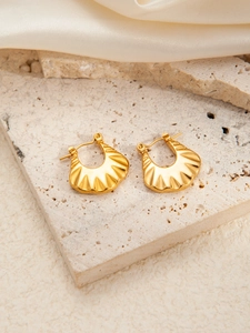 Detailed close-up of gold stainless steel earrings with radiant fan-shaped pleats texture