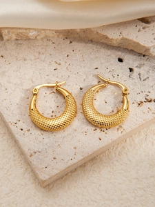 Close-up of gold-plated stainless steel earrings with embossed diamond texture on stone