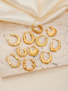 Selection of textured golden hoop earrings featuring hammered, twisted, and wavy patterns