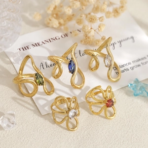 Golden stainless steel rings set featuring flower and curved designs with colorful zircon