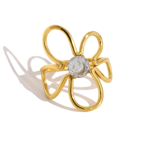 Macro detail of gold flower ring featuring a sparkling zircon stone and hollow petal lines