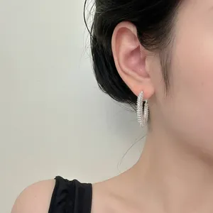 Silver woven texture hoop earrings for women featuring a shimmering textured metal finish