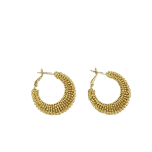 Elegant gold hoop earrings with textured beadwork and woven metallic finish for women