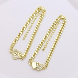 Golden Cuban link bracelets with heart pendants and sparkling zircon inlays on white background