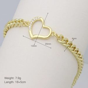 Close-up of gold Cuban link bracelet with heart pendant and zircon stones on white display