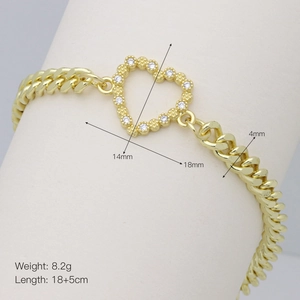 Macro detail of gold Cuban chain bracelet with 18x14mm zircon heart pendant